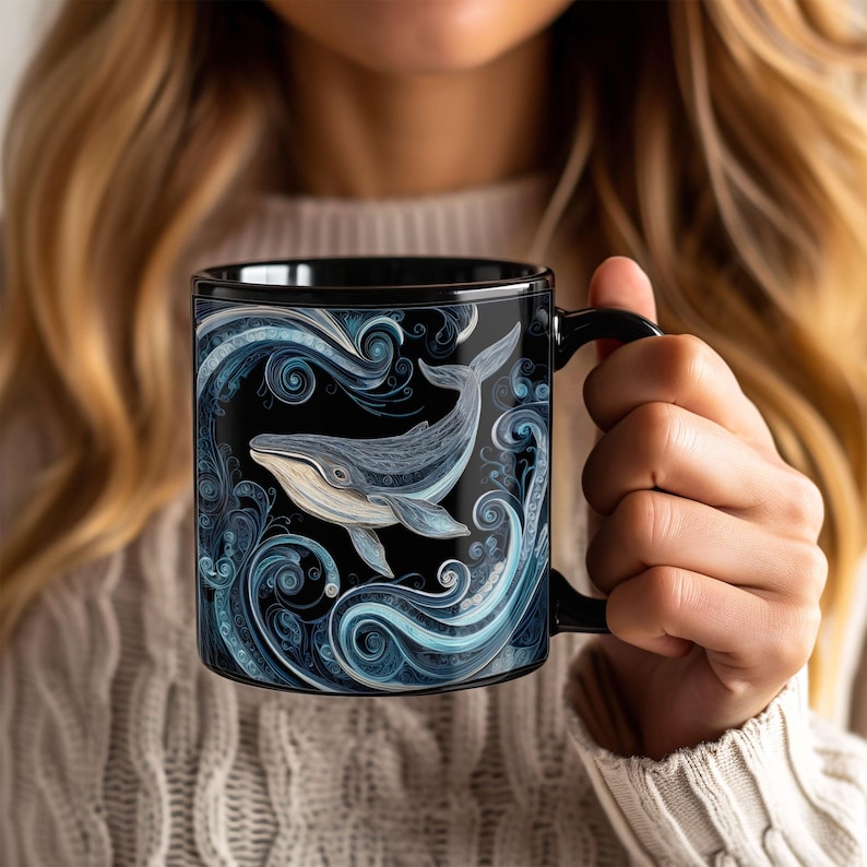 May include: Black ceramic mug featuring a detailed illustration of a whale swimming in blue and white swirling water patterns. The mug has a black handle and interior, creating a striking contrast with the marine design. A unique gift for ocean lovers.