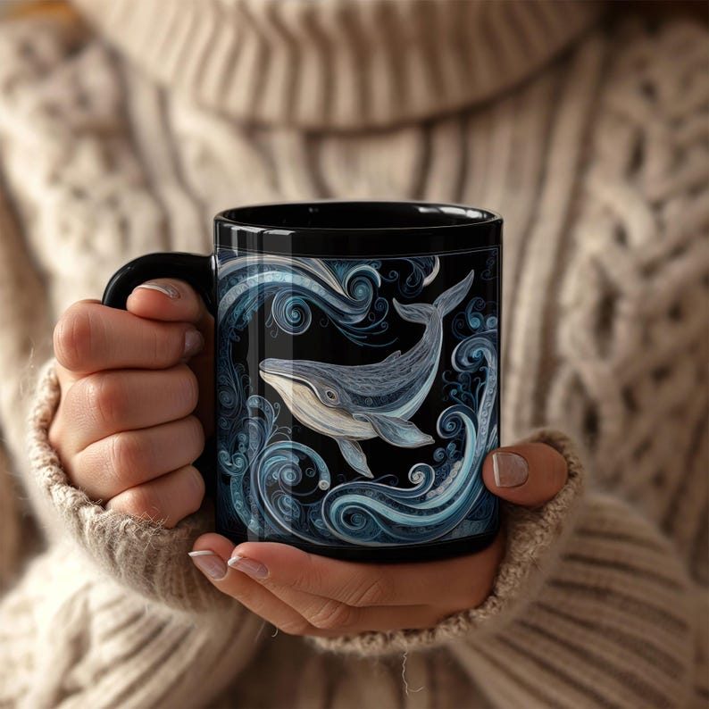 May include: Black ceramic mug featuring a detailed illustration of a whale swimming in stylized blue waves. The whale is depicted in shades of gray and white against a black background. The mug has a black handle.