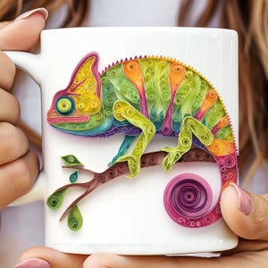 May include: White ceramic mug with a vibrant chameleon design. The chameleon, in shades of green, yellow, and purple, is perched on a brown branch with green leaves. The tail is curled. The mug has a white handle.