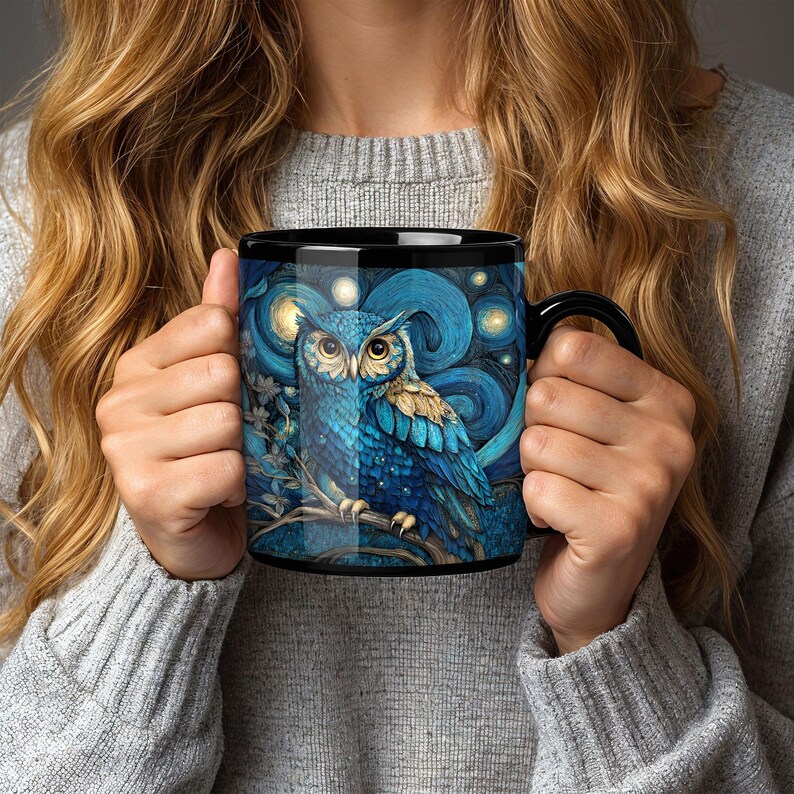 May include: A black ceramic mug featuring a vibrant blue owl perched on a branch against a swirling, starry night sky background. The owl has detailed feathers, large yellow eyes, and is surrounded by glowing golden orbs in a painterly style.