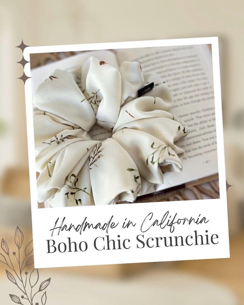 May include: Cream-colored scrunchie with a floral pattern. The fabric is gathered and voluminous, with small brown leaf-like designs. The scrunchie is handmade in California. The text "Boho Chic Scrunchie" is also visible.