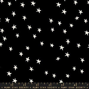 May include: A black fabric featuring a scattered pattern of off-white, hand-drawn style stars. Along the bottom edge, a ruler is visible with markings up to 7 inches, accompanied by the repeated text "RUBY STAR SOCIETY" and small star icons.
