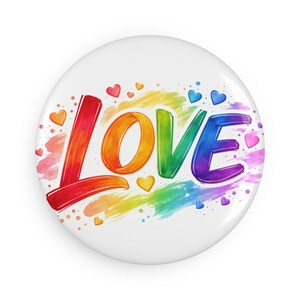 Pode incluir: Um botão branco com a palavra "LOVE" em cores do arco-íris. As letras são contornadas em preto e rodeadas por um gradiente de arco-íris e pequenos corações em várias cores.
