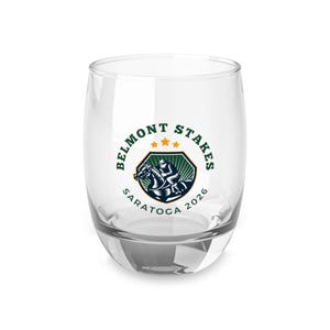 May include: A clear, stemless wine glass with the Belmont Stakes logo in green, navy, and gold. The logo features a horse and jockey, with the text "Belmont Stakes Saratoga 2026" encircling the design. The glass is ideal for serving wine.