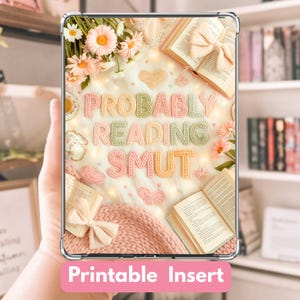 May include: A clear tablet case with a pink and white background featuring the text "PROBABLY READING SMUT" in colourful yarn lettering. The design includes open books, flowers, and hearts. The words "Printable Insert" are at the bottom.