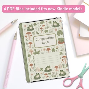 May include: A clear Kindle cover with a whimsical design featuring frogs, mushrooms, and foliage. The cover has the words "Composition Book" on the front. Two pink pens and a pair of pink scissors are also in the image.