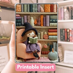 May include: A clear phone case with a colorful, whimsical design featuring a doll reading in a chair in front of a bookshelf. The words "Printable Insert" are displayed in a pink banner at the bottom.