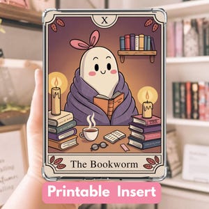 May include: A clear phone case with a "The Bookworm" tarot card design. The illustration features a cartoon bookworm character wrapped in a blanket, reading a book, with candles, books, and a cup of coffee. The text "Printable Insert" is at the bottom.