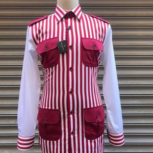 May include: A red and white striped long-sleeved shirt with a button-up front and multiple pockets. The shirt has a white collar and cuffs with red stripes.
