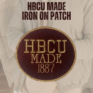 May include: A maroon and gold iron-on patch with the text "HBCU MADE" and "1887" in gold lettering. The patch is circular with a gold border. The words "HBCU MADE IRON ON PATCH" are printed above the patch.