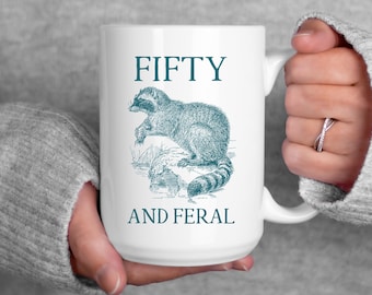 Fifty and Feral Mug, Funny Gift for Women Over 50, Midlife Crisis Coffee Cup, Snarky Raccoon Humor, Feral Girl Energy, 11oz 15oz