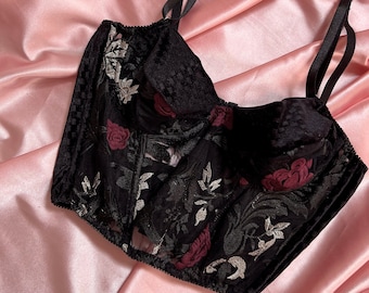 Black corset embroidered with burgundy flowers