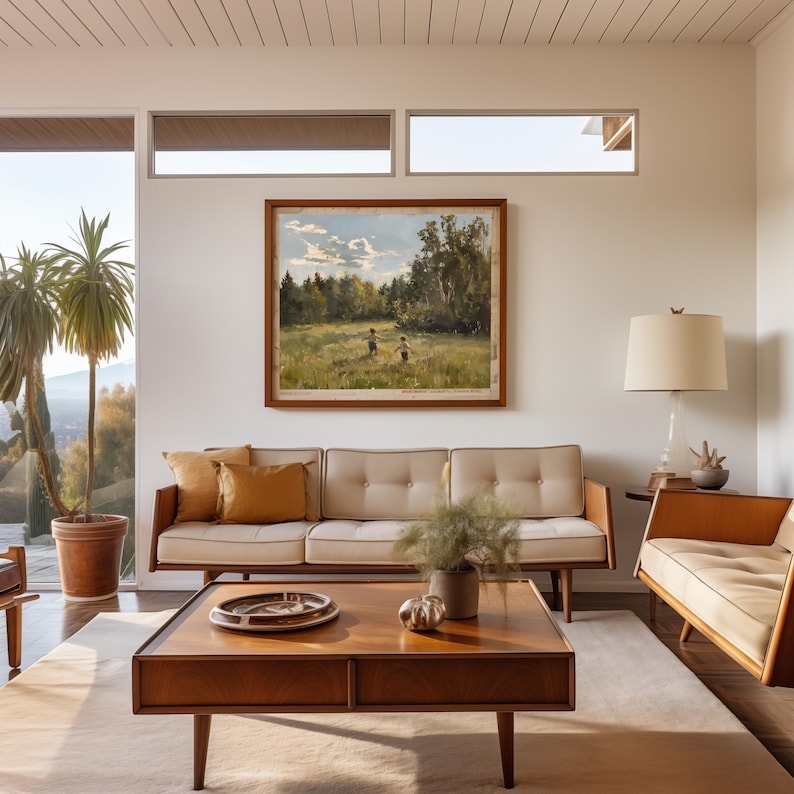 May include: A living room with a white couch, a wooden coffee table, a brown armchair, and a framed landscape painting on the wall. The room has a large window with a view of trees and a wooden ceiling.