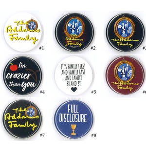 May include: A collection of eight circular pin-back buttons featuring The Addams Family themes. Designs include yellow text on white or black backgrounds, character portraits in gold frames, a red apple icon, and text reading Full Disclosure.