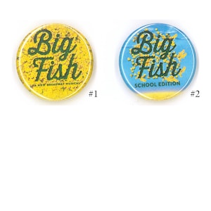 May include: Two round buttons with the words "Big Fish" in green script. One button is yellow with the text "A New Broadway Musical". The other is blue with "School Edition".
