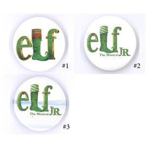 May include: Three circular white buttons featuring the word elf with a green boot replacing the letter l. Button one shows gold lettering. Button two adds the text The Musical JR. Button three includes the same text over a light blue horizon.