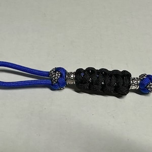 Lanyard for knife, flashlight, key fob, keychain, EDC (every day carry) etc.   550 Paracord.  Your choice of colors, lengths, & knots.