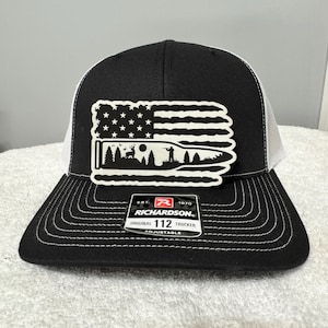 May include: A white ceramic mug with a black handle and the text "But First, Coffee" in a black, bold font. The mug is on a white surface. The mug is likely used for hot beverages.