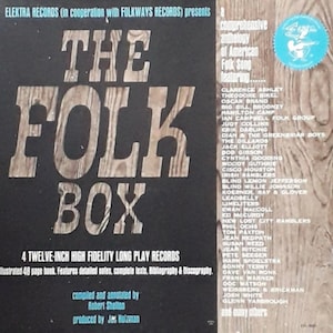 May include: A black and white album cover with the title "The Folk Box" in large, bold letters. The cover features a list of artists including Clarence Ashley, Theodore Bikel, Oscar Brand, Big Bill Broonzy, Hamilton Camp, Ian Campbell Folk Group, Judy Collins, Erik Darling, Dian & The Greenbriar Boys, The Dillards, Jack Elliott, Bod Gibson, Cynthia Gooding, Woody Guthrie, Cisco Houston, Irish Ramblers, Blind Lemon Jefferson, Blind Willie Johnson, Koerner, Ray & Glover, Leadbelly, Limeliters, Ewan MacColl, Ed McCurdy, New Lost City Ramblers, Phil Ochs, Tom Paxton, Jean Redpath, Susan Reed, Jear Ritchie, Pete Seeger, Mark Spoelstra, Sonny Terry, Dave Van Ronk, Frank Warner, Ooc Watson, Weissberg & Brickman, Josh White, Glenn Yarbrough, and many others.