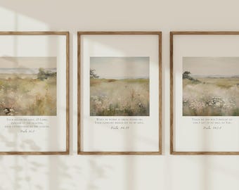 May include: Three framed landscape prints with a serene meadow scene in muted tones. Each print features a different Bible verse in a classic serif font. The frames are a warm, natural wood color, adding to the rustic aesthetic.