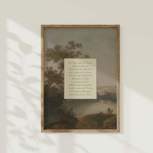 Pode incluir: Impressão emoldurada com uma paisagem pastoral com um rio e árvores. Um retângulo branco no centro exibe o texto da Oração do Senhor em preto. A moldura é de cor castanho claro.