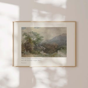 May include: Framed watercolor landscape art print. The artwork features a serene scene with trees, a mountain, and a soft, muted color palette. Text at the bottom reads, "When my heart is overwhelmed lead me to the Rock that is higher than I. PSALM 61:2."