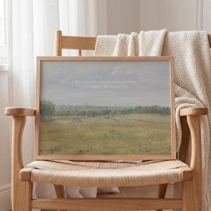May include: A rectangular framed landscape print featuring a muted green and brown field under a soft sky. The text "THIS IS THE DAY THAT THE LORD HAS MADE; LET US REJOICE AND BE GLAD IN IT. Psalm 118:24" is printed in white across the center of the image.