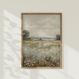 May include: A framed print with a watercolor painting of a field of white flowers. The print includes the text "Give thanks to the Lord, for He is good; His love endures forever. 1 Chronicles 16:34".