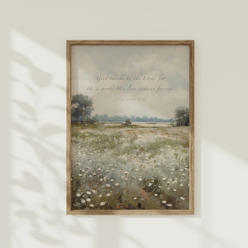 May include: A framed landscape print featuring a field of white flowers under a cloudy sky. The artwork includes the text "Give thanks to the Lord, for He is good; His love endures forever. 1 Chronicles 16:34."