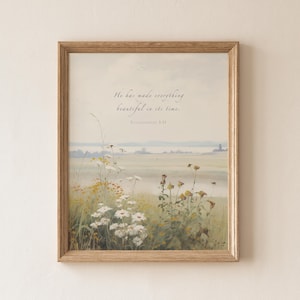 May include: A framed print depicting a serene landscape with wildflowers. The artwork has a soft colour palette and includes the quote: "He has made everything beautiful in its time. Ecclesiastes 3:11."