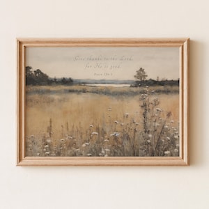 May include: A framed landscape print featuring a field of tall grass and wildflowers in shades of tan and white. The sky is a soft blue with a hint of clouds. The text "Give thanks to the Lord, for He is good. Psalm 136:1" is at the top.