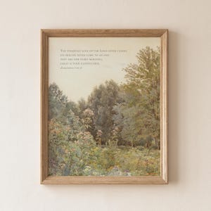 May include: A framed wall art print featuring a landscape painting of a lush forest and wildflower meadow. The text reads: The steadfast love of the Lord never ceases; his mercies never come to an end; they are new every morning; great is your faithfulness. Lamentations 3:22-23.