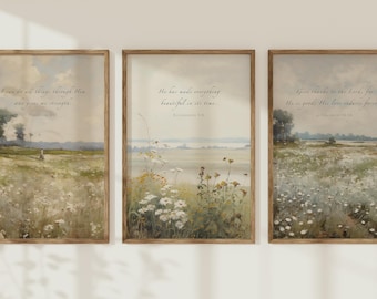 May include: A set of three vertical wall art prints in wooden frames, each featuring a landscape painting of a wildflower meadow under a cloudy sky. The prints include script text with religious verses, specifically Philippians 4:13, Ecclesiastes 3:11, and 1 Chronicles 16:34, set against soft, muted tones of green, white, and yellow.