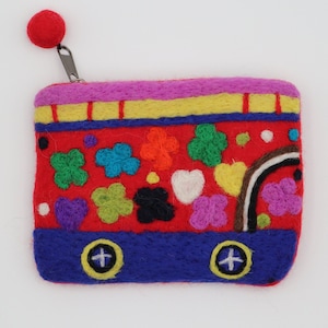 May include: A red felt coin purse with a colorful bus design. The purse features a zipper with a red pom-pom pull. The bus has blue wheels, a rainbow, and various embroidered flowers and hearts in shades of green, orange, and purple.