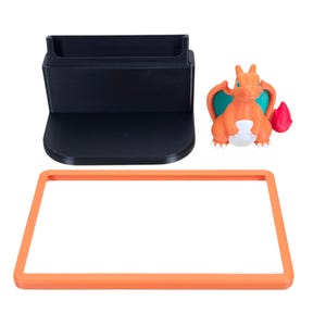 May include: A black plastic stand with a curved base and a slot, an orange rectangular frame, and an orange and white Charizard figurine with teal wings and a red flame.