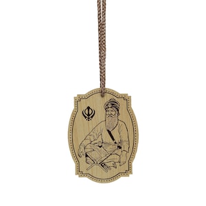May include: A wooden pendant with a brown rope, featuring a black and white illustration of a Sikh Guru with a turban, beard, and a book. The pendant also includes a Khanda symbol.
