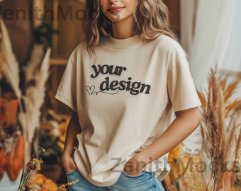 May include: A beige t-shirt with short sleeves and the text "your design" printed on the front. The shirt is being worn by a person with long brown hair.