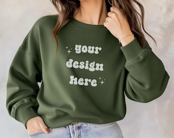 May include: A green sweatshirt with the text "your design here" in a retro font with white stars on either side.