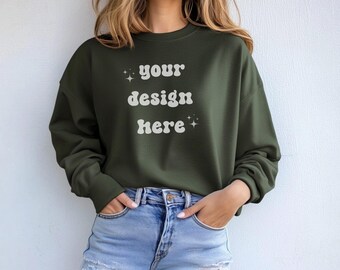 May include: A dark green sweatshirt with the text "your design here" in white lettering. The sweatshirt has a relaxed fit and is perfect for layering.