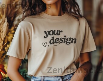 May include: A beige t-shirt with short sleeves and the text "your design" printed on the front. The text is in a black, retro font with a small heart design.