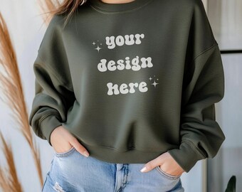 May include: A dark green sweatshirt with the text "your design here" in white. The sweatshirt has a relaxed fit and is made of a soft, comfortable fabric.