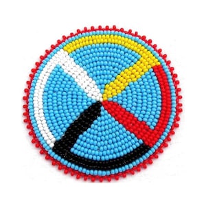 May include: A beaded Native American medicine wheel with a blue background, red, yellow, white and black sections.