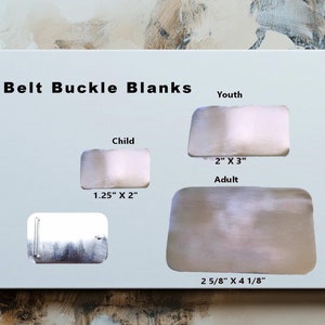 May include: A white board with the text "Belt Buckle Blanks" and different sizes of metal belt buckle blanks labeled "Youth", "Child", and "Adult" with their corresponding measurements in inches.
