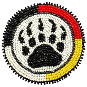 May include: A circular beaded design with a bear paw print. The design uses black, white, red, and yellow beads. The outer edge is black with a scalloped border. The bear paw is black and white.