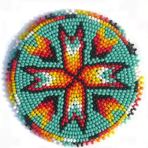 May include: Round beaded coaster with a turquoise background and a central starburst design. The starburst features red, yellow, and white accents. The coaster's edge is bordered with black, red, yellow, and white beads.