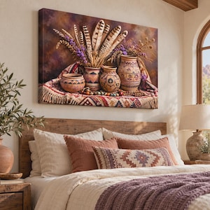 May include: A rectangular canvas wall art print featuring four earthenware pots arranged on a patterned textile with fringe. The pots contain dried grasses, purple flowers, and brown-and-white striped feathers against a dark, moody background.