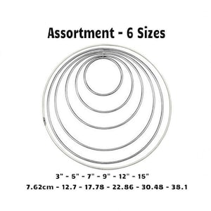 May include: Assortment of six metal hoops in different sizes, ranging from 3 inches to 15 inches. The hoops are arranged in a circle, with the largest hoop on the outside and the smallest hoop on the inside. The text "Assortment - 6 Sizes" is written above the hoops. The text "3" - 5" - 7" - 9" - 12" - 15" is written below the hoops. The text "7.62cm - 12.7 - 17.78 - 22.86 - 30.48 - 38.1" is written below the text "3" - 5" - 7" - 9" - 12" - 15".