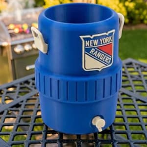May include: A blue beverage cooler with the New York Rangers logo. The cooler has a spigot, white handles, and a ribbed design. It is sitting on a black metal table outdoors.