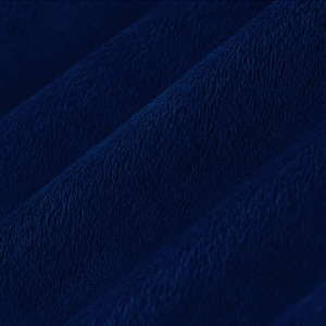 May include: Close-up of a deep blue fabric with a textured, slightly fuzzy surface. The fabric is folded in a series of gentle waves, creating a soft and inviting look.