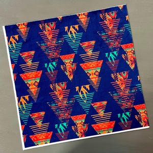May include: A navy blue fabric with a repeating pattern of colorful triangles. The triangles have a variety of patterns, including stripes, zigzags, and geometric designs. The fabric is perfect for crafting projects, such as quilts, pillows, and bags.